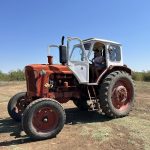 1.Vintage tractor на открито с ясно синьо небе в България.