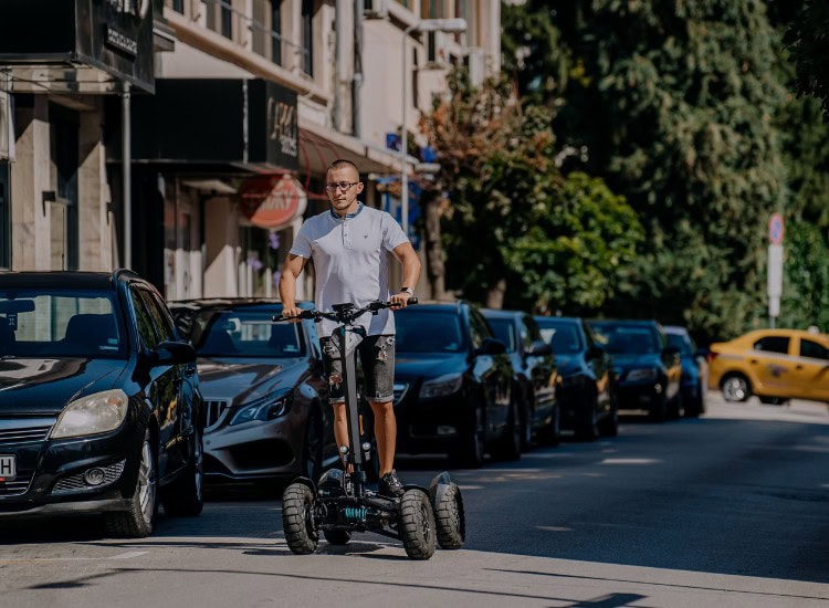 A street in Bulgaria, a man riding an electric scooter, an urban landscape, a modern way of getting around.