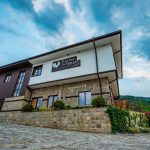 Exterior of Hillview Bulgaria hotel complex with natural landscape in the background.