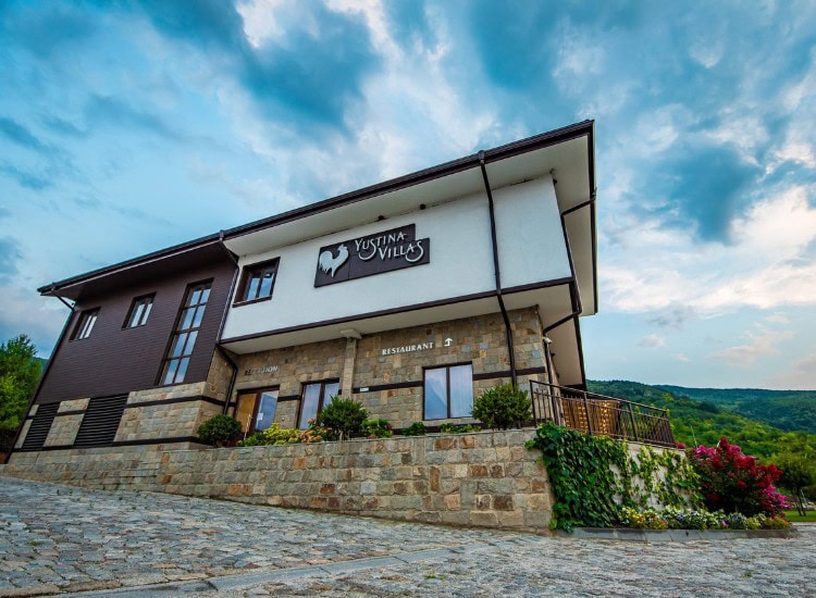 Exterior of Hillview Bulgaria hotel complex with natural landscape in the background.
