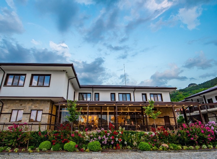Hillview Bulgaria's restaurant overlooks the mountain and features a flower garden.